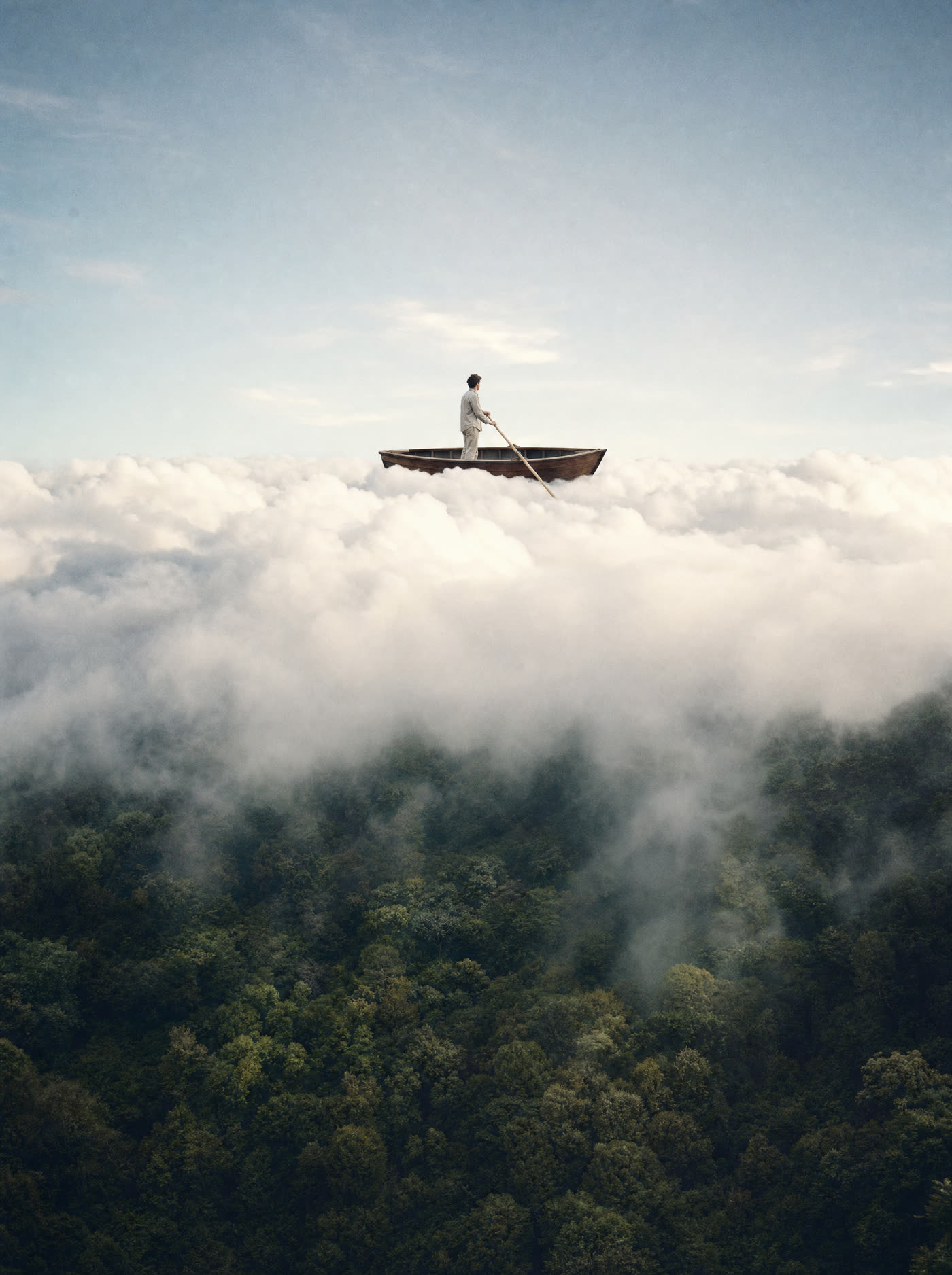 A forest canopy dissolving into cumulus cloud, a wooden boat and lone rower floating on top of it